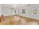Bright bedroom features hardwood floors, white walls, a ceiling fan, and large windows at 156 Hazelton Loop, Mooresville, NC 28117