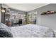 Well-lit bedroom with a comfortable bed, modern desk and shelving, providing a functional and restful space at 156 Hazelton Loop, Mooresville, NC 28117