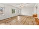 Bright bedroom features hardwood floors, white walls, and large windows overlooking the yard at 156 Hazelton Loop, Mooresville, NC 28117
