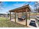 A lovely waterfront covered gazebo featuring a ceiling fan and dining table for entertaining at 156 Hazelton Loop, Mooresville, NC 28117