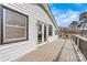 Wide shot of a wooden deck on the home's white exterior and window trim at 156 Hazelton Loop, Mooresville, NC 28117