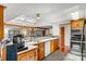 Well-lit kitchen with wood cabinets, granite countertops, and a view to the dining area at 156 Hazelton Loop, Mooresville, NC 28117