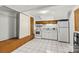 A compact kitchen with a white oven, cabinets, and tile flooring provides a functional cooking space at 156 Hazelton Loop, Mooresville, NC 28117