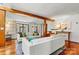 Bright living room with hardwood floors, white sofas, and a striking wood beam accent at 156 Hazelton Loop, Mooresville, NC 28117