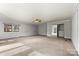 Spacious living room featuring neutral walls, carpeted flooring, and a ceiling fan for climate control with large windows at 156 Hazelton Loop, Mooresville, NC 28117