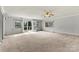 Bright living room with neutral walls, carpeted floors, ceiling fan, and a glass patio door that offers access to the outdoors at 156 Hazelton Loop, Mooresville, NC 28117