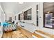 Bright sunroom with hardwood floors, built-in shelving, and multiple windows at 156 Hazelton Loop, Mooresville, NC 28117