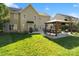 A spacious backyard features a covered patio with bar seating, lounge furniture, and a lush green lawn at 2000 Willowcrest Dr, Waxhaw, NC 28173