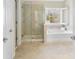 Bright bathroom featuring a separate shower and tub with a view of the outdoors at 2000 Willowcrest Dr, Waxhaw, NC 28173