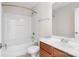 Bright bathroom featuring a tub and shower combination, tile floors, and a wooden vanity at 2000 Willowcrest Dr, Waxhaw, NC 28173