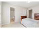 Cozy bedroom with ensuite bathroom features a classic wood bed frame and neutral carpet at 2000 Willowcrest Dr, Waxhaw, NC 28173