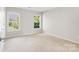 Well lit bedroom showcasing carpet floors and two windows letting in lots of natural light at 2000 Willowcrest Dr, Waxhaw, NC 28173