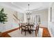 Stylish dining area with wainscoting, hardwood floors, and a modern chandelier at 2000 Willowcrest Dr, Waxhaw, NC 28173