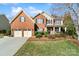 Charming brick home with a two-car garage, manicured lawn, and inviting front porch at 2000 Willowcrest Dr, Waxhaw, NC 28173