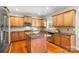 Well-lit kitchen features custom cabinets, stainless steel appliances, and a functional island for meal preparation at 2000 Willowcrest Dr, Waxhaw, NC 28173