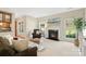 Comfortable living room featuring a fireplace, large windows, and plush seating at 2000 Willowcrest Dr, Waxhaw, NC 28173