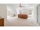 Spacious main bedroom featuring a ceiling fan, large windows, and carpeted flooring at 2000 Willowcrest Dr, Waxhaw, NC 28173