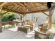 Relax in this outdoor living space with seating, bar, ceiling fan, and mounted tv at 2000 Willowcrest Dr, Waxhaw, NC 28173