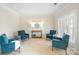 Cozy sitting room with neutral walls, plantation shutters, and comfortable blue chairs at 2000 Willowcrest Dr, Waxhaw, NC 28173