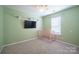 Cozy Bedroom featuring a pink crib, a wall mounted TV, and a ceiling fan at 2007 Wexford Way, Statesville, NC 28625