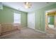 Well lit Bedroom featuring a crib, closet, carpet, and a ceiling fan at 2007 Wexford Way, Statesville, NC 28625