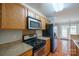 Well-equipped kitchen with stainless steel appliances, light wood cabinets, and a tiled backsplash at 2007 Wexford Way, Statesville, NC 28625