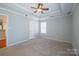 The main bedroom with tray ceiling is spacious and well lit at 2007 Wexford Way, Statesville, NC 28625
