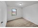 Simple bedroom design featuring neutral walls, carpet, and window for natural light at 2015 Springfield Ct, Gastonia, NC 28052