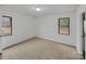 Cozy bedroom with neutral carpeting, two windows, and a closet at 2015 Springfield Ct, Gastonia, NC 28052