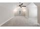 Spacious bonus room with neutral carpet, tall ceilings, fan and natural light at 21013 Island Forest Dr, Cornelius, NC 28031
