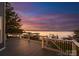 Spacious deck with railing offering panoramic sunset views of the lake and dock at 21013 Island Forest Dr, Cornelius, NC 28031