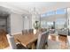 Open-concept dining area with lake views, chandelier, and stylish furnishings at 21013 Island Forest Dr, Cornelius, NC 28031