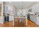 Bright kitchen with white cabinetry, granite countertops, stainless steel appliances, and a center island at 21013 Island Forest Dr, Cornelius, NC 28031
