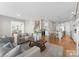Open-concept living room with hardwood floors, neutral decor, and staircase to the upper level at 21013 Island Forest Dr, Cornelius, NC 28031
