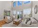 Bright living room with soaring ceilings, large windows, and beautiful views at 21013 Island Forest Dr, Cornelius, NC 28031