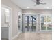 Bright room with large windows showcasing lake views, access to the outside, and a bathroom at 21013 Island Forest Dr, Cornelius, NC 28031