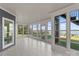 The sunroom boasts floor-to-ceiling windows and tranquil lake views at 21013 Island Forest Dr, Cornelius, NC 28031