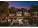 Stunning waterfront property with private dock and serene lake views at twilight, perfect for luxurious lakeside living at 21013 Island Forest Dr, Cornelius, NC 28031