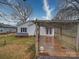 Backyard view with a wooden pergola, and a white house with black shutters at 211 9Th St, Belmont, NC 28012