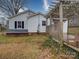 A home's backyard with a wooden pergola attached to the house, offering a great space for outdoor relaxation at 211 9Th St, Belmont, NC 28012