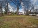 Expansive backyard featuring mature trees and an outbuilding, perfect for outdoor activities at 211 9Th St, Belmont, NC 28012