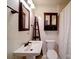 Bathroom with floral-themed wallpaper, mirror, and a white pedestal sink at 211 9Th St, Belmont, NC 28012