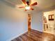 Bedroom with hardwood floors, ceiling fan, and views of the bathroom and kitchen at 211 9Th St, Belmont, NC 28012