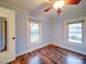 This bedroom features hardwood floors, light-blue walls, two windows allowing for natural light, and a closet at 211 9Th St, Belmont, NC 28012