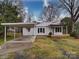 Charming house with a covered parking area and a well-maintained front yard at 211 9Th St, Belmont, NC 28012