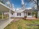Charming one-story home with white siding, covered porches, and a convenient carport for parking at 211 9Th St, Belmont, NC 28012