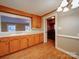 Inviting kitchen area with spacious countertops, stainless steel refrigerator, and open doorway to laundry area at 211 9Th St, Belmont, NC 28012