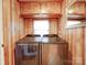 Up-to-date laundry room featuring newer model washer-dryer, wood paneling and plenty of cabinet space at 211 9Th St, Belmont, NC 28012