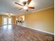 Open living room featuring hardwood flooring, ceiling fan, and a view of the kitchen through a pass-through window at 211 9Th St, Belmont, NC 28012