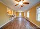 Large living room with hardwood floors, a pass-through to the kitchen, and views to the backyard at 211 9Th St, Belmont, NC 28012